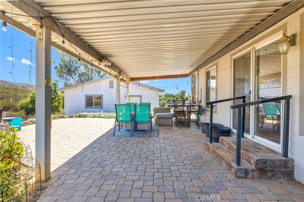 35125 Stirrup Road Temecula, CA 92592 - Photo 30 of 51 a view of a porch with chairs and backyard