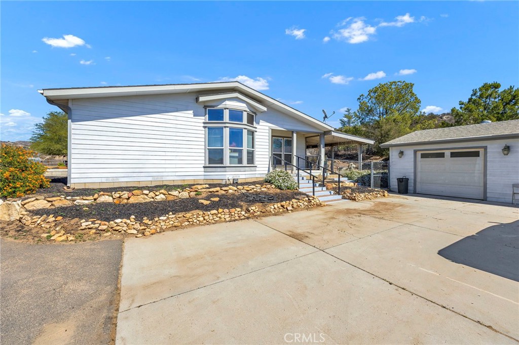 35125 Stirrup Road Temecula, CA 92592 - Photo 32 of 51 a front view of a house with a yard