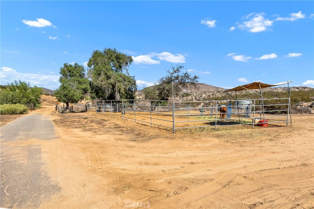 35125 Stirrup Road Temecula, CA 92592 - Photo 39 of 51 a view of swimming pool with a lawn chairs under an umbrella