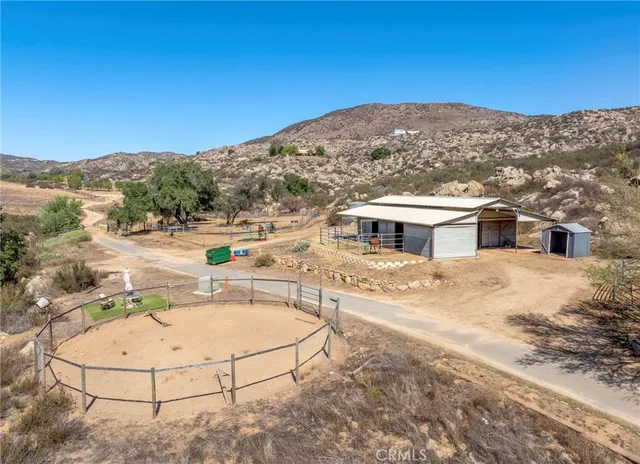a view of a house with pool and furniture