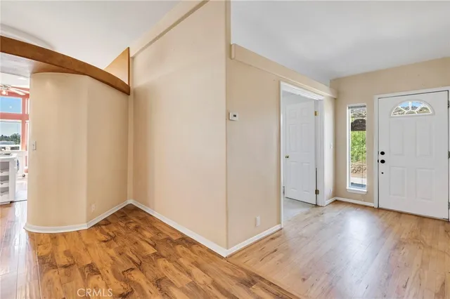 a view of a room with wooden floor and a window