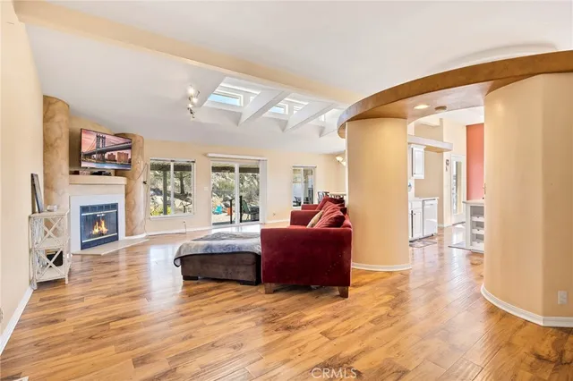 a living room with fireplace furniture and a wooden floor