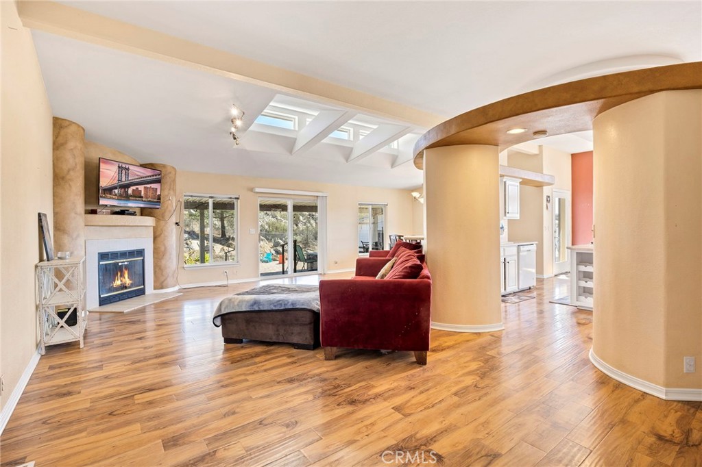35125 Stirrup Road Temecula, CA 92592 - Photo 6 of 51 a living room with fireplace furniture and a wooden floor