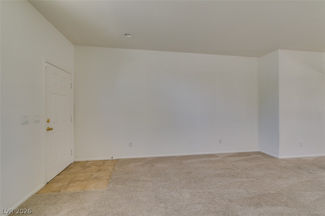 5150 Riverside Run Court North Las Vegas, NV 89081 - Photo 7 of 50 A well-lit interior space awaits your personal touch with soft carpeting and clean white walls.