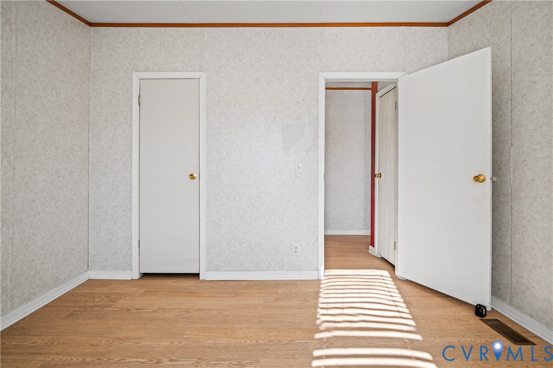 14306 Wilkinson Road Dewitt, VA 23840 - Photo 25 of 60 Wood-finish flooring with white trim and a white d