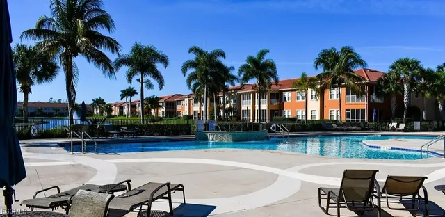 a swimming pool with outdoor seating and yard