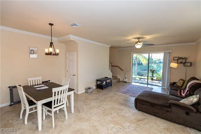 a living room with furniture a ceiling fan and a window