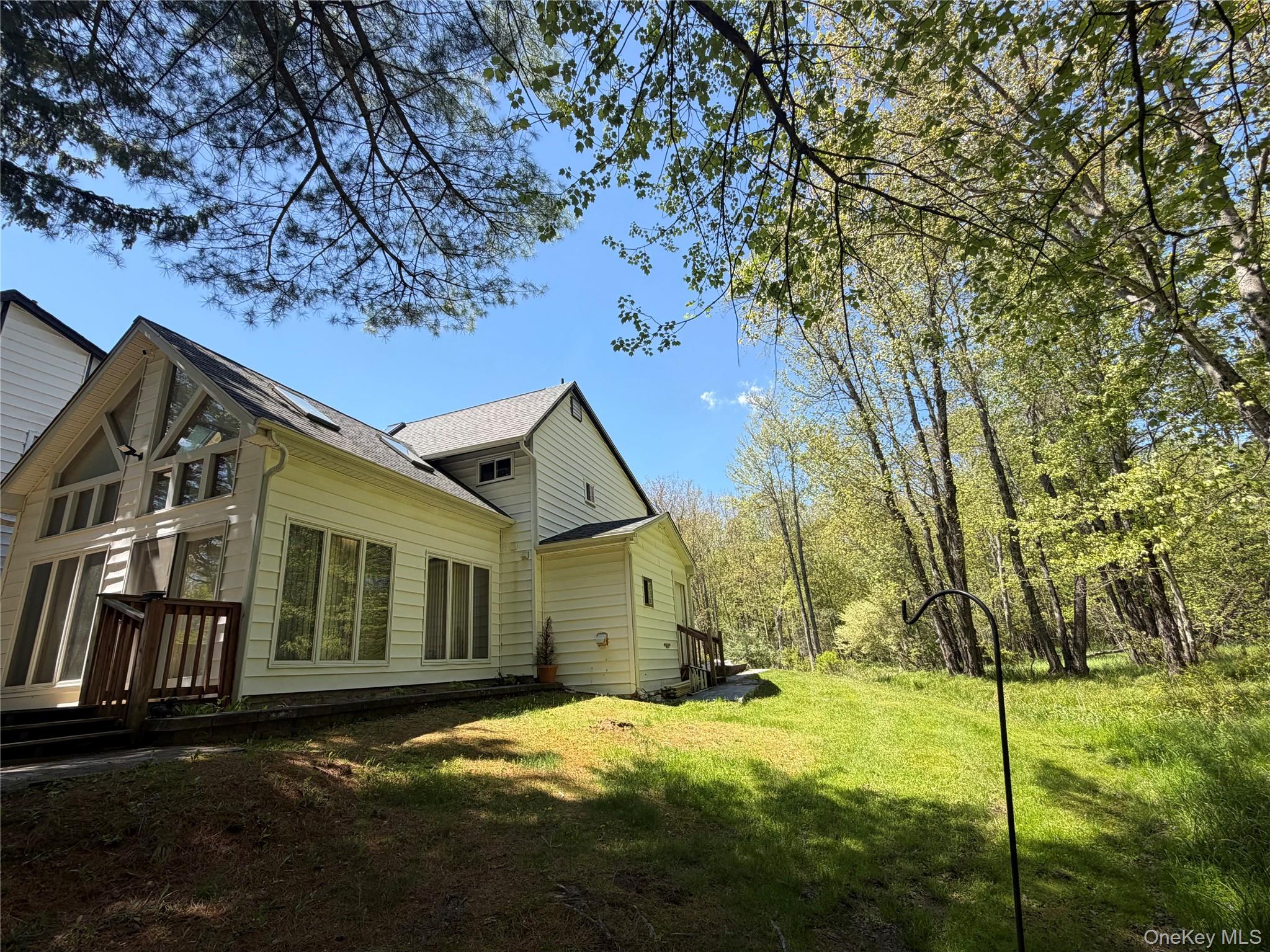 60 Medallion Road Kiamesha Lake, NY 12751 - Photo 14 of 44 a backyard of a house with table and chairs