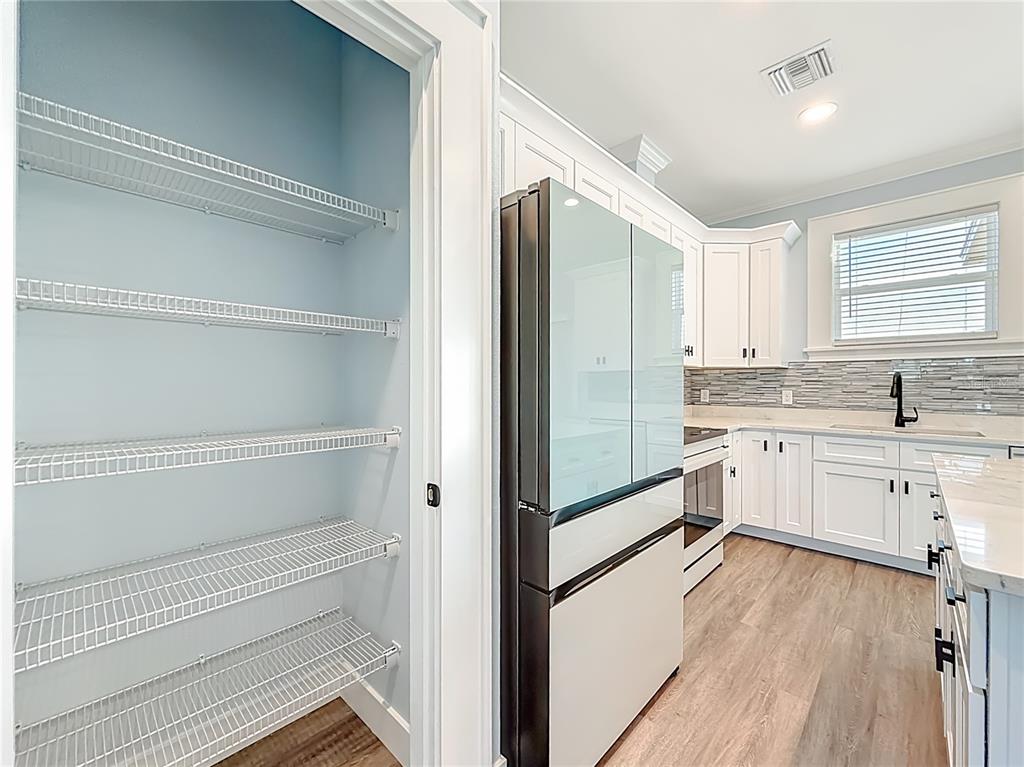 12847 Southwest 73rd Street Ocala, FL 34473 - Photo 11 of 28 a kitchen with white cabinets and white appliances