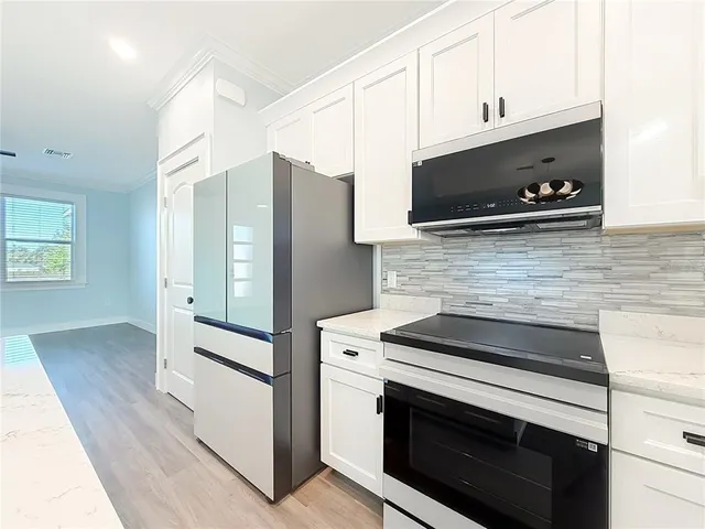a kitchen with granite countertop cabinets and steel stainless steel appliances