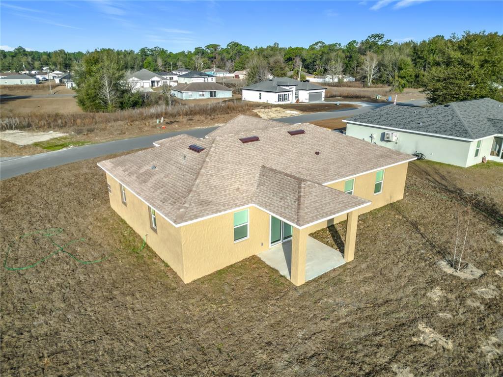 12847 Southwest 73rd Street Ocala, FL 34473 - Photo 23 of 28 an aerial view of a house with a yard and lake view