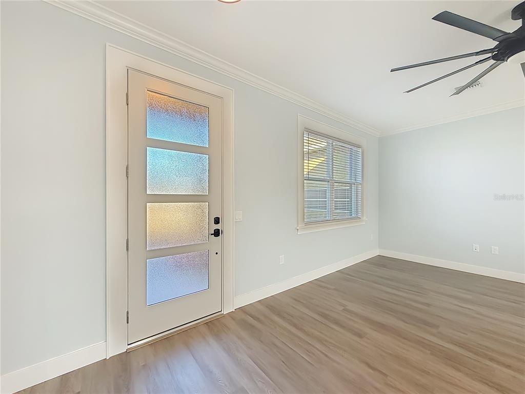 12847 Southwest 73rd Street Ocala, FL 34473 - Photo 8 of 28 an empty room with wooden floor cabinet and windows