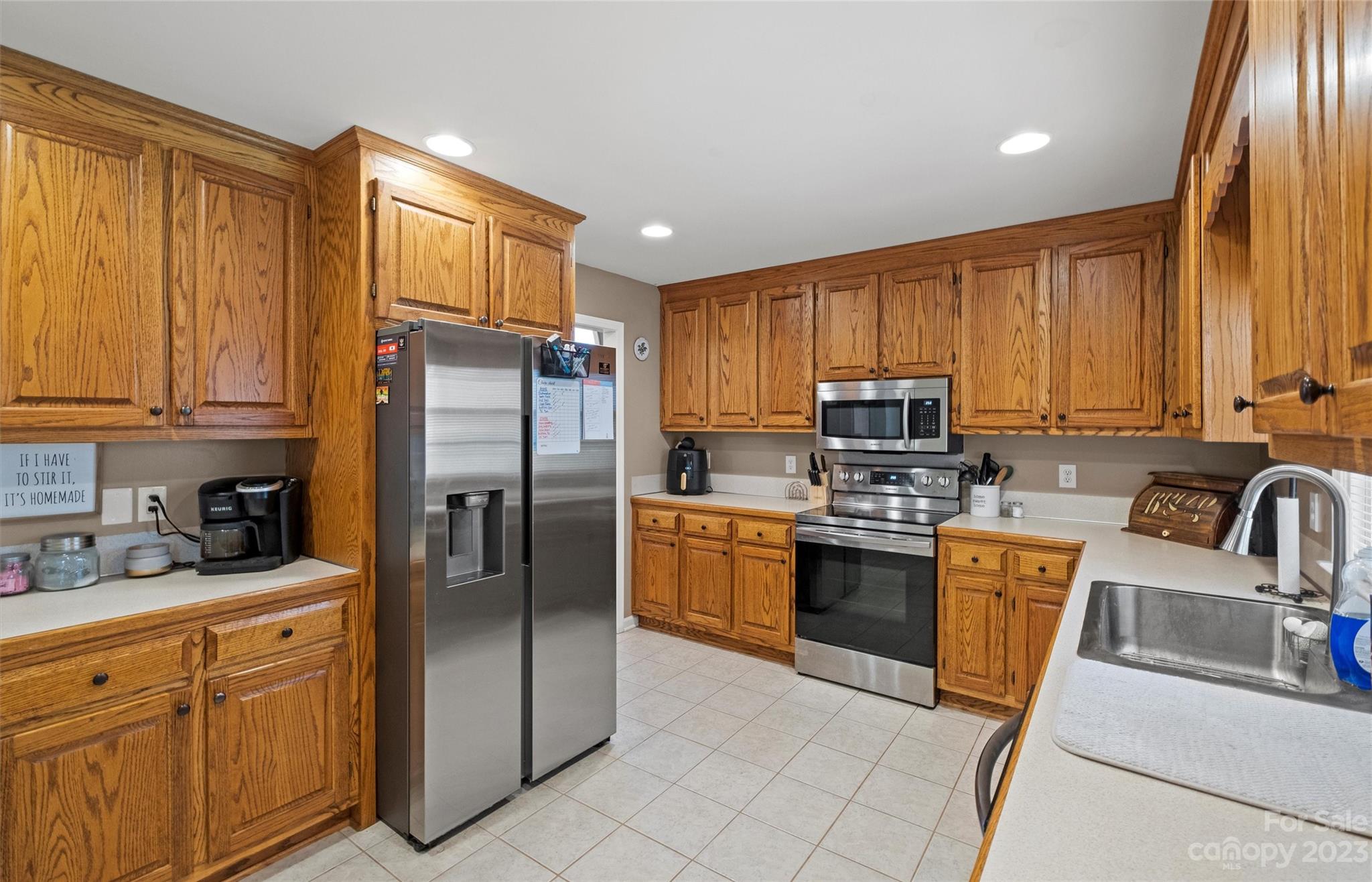 614 Maple Ridge Circle Salisbury, NC 28147 - Photo 16 of 46 a kitchen with granite countertop stainless steel appliances a refrigerator sink and microwave