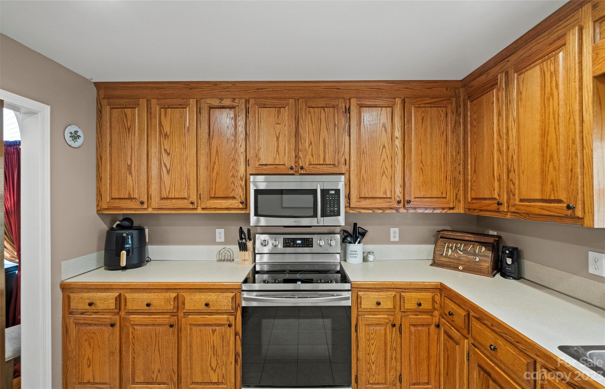 614 Maple Ridge Circle Salisbury, NC 28147 - Photo 17 of 46 a kitchen with stainless steel appliances granite countertop a stove a sink dishwasher and a microwave oven with cabinets