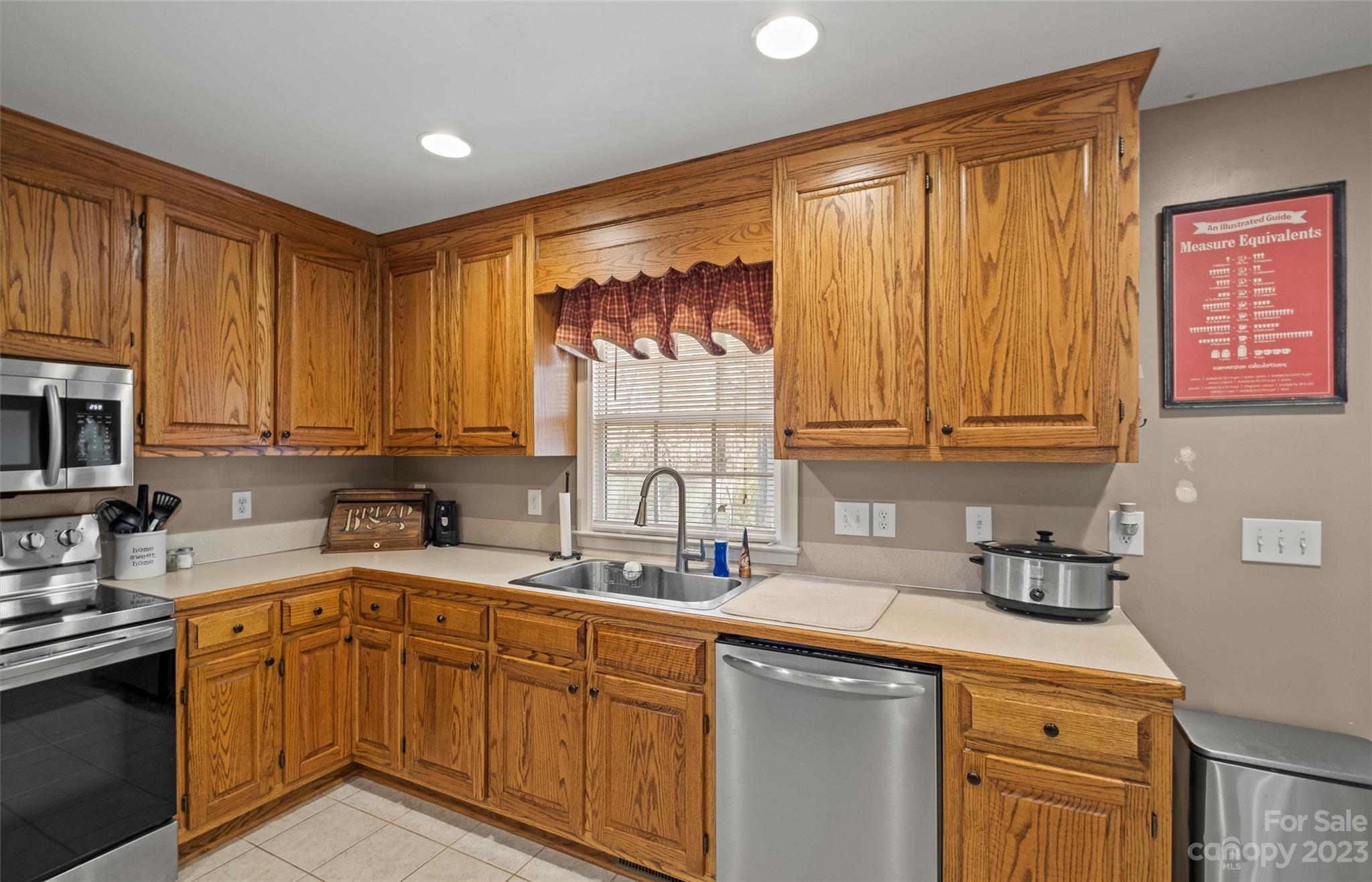 614 Maple Ridge Circle Salisbury, NC 28147 - Photo 18 of 46 a kitchen with stainless steel appliances a sink cabinets and a window