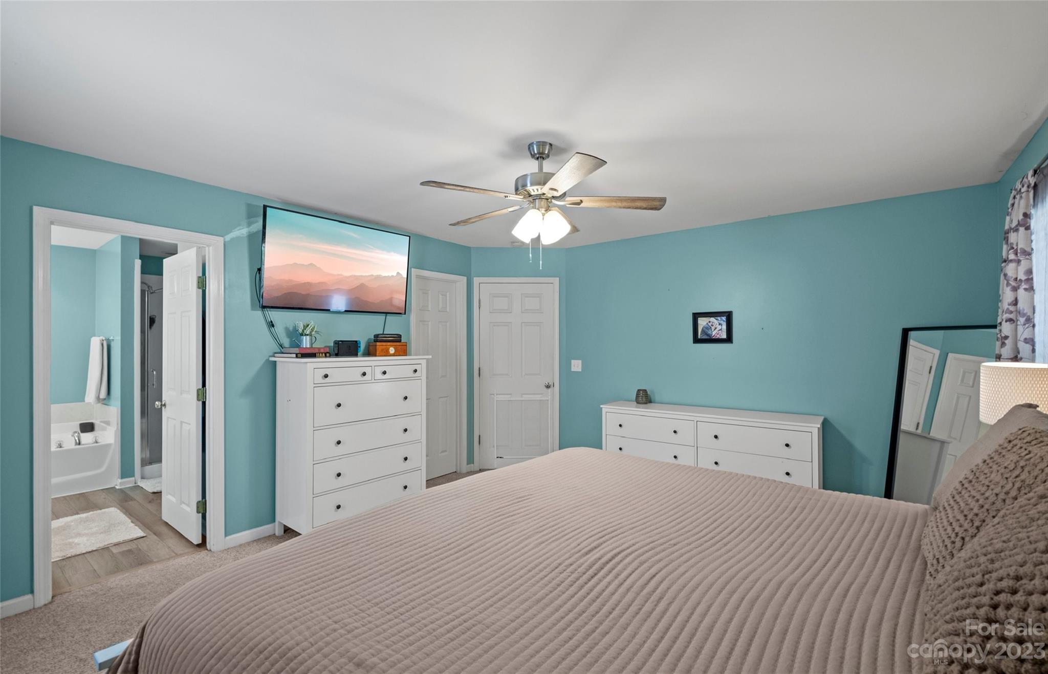 614 Maple Ridge Circle Salisbury, NC 28147 - Photo 23 of 46 a bedroom with a large bed and a flat tv screen on dresser