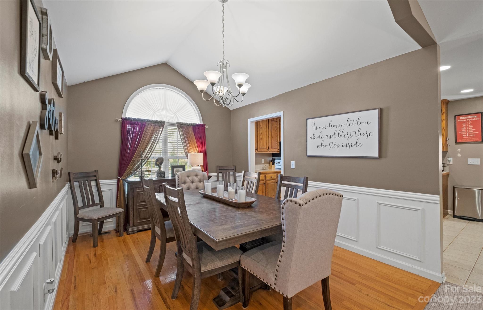 614 Maple Ridge Circle Salisbury, NC 28147 - Photo 9 of 46 a view of a dining room with furniture a chandelier and wooden floor