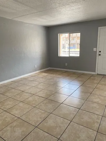a view of a kitchen with white cabinets