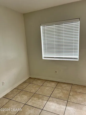 a view of a livingroom with an empty space and a window