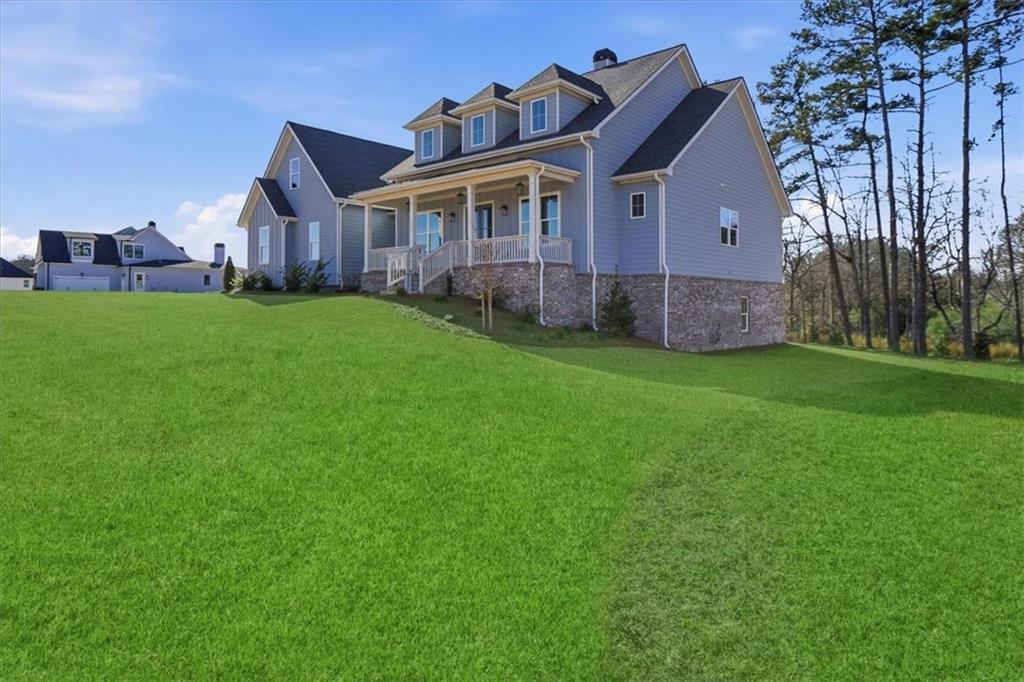 216 Ewing Way Dacula, GA 30019 - Photo 2 of 80 a view of a big house with a big yard and large trees