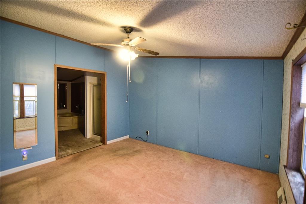 3172 Old Rte 8 Polk, PA 16342 - Photo 12 of 18 a view of a livingroom with a chandelier fan and a bathroom