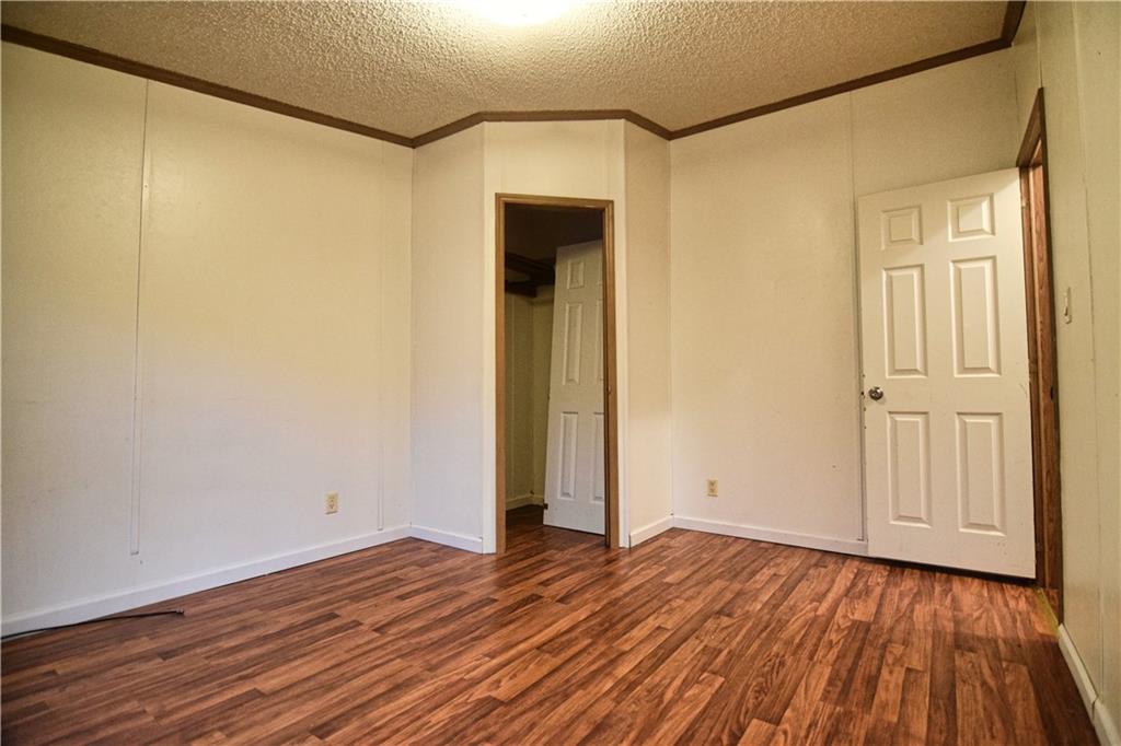 3172 Old Rte 8 Polk, PA 16342 - Photo 13 of 18 a view of an empty room with wooden floor and a window