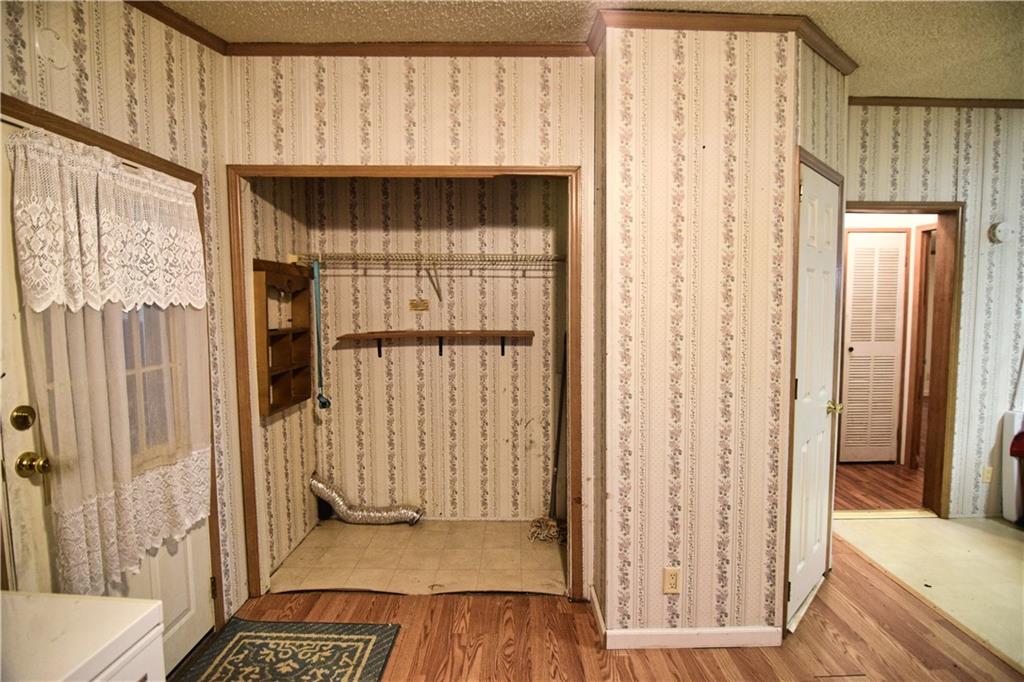 3172 Old Rte 8 Polk, PA 16342 - Photo 15 of 18 a view of a hallway with wooden floor and door