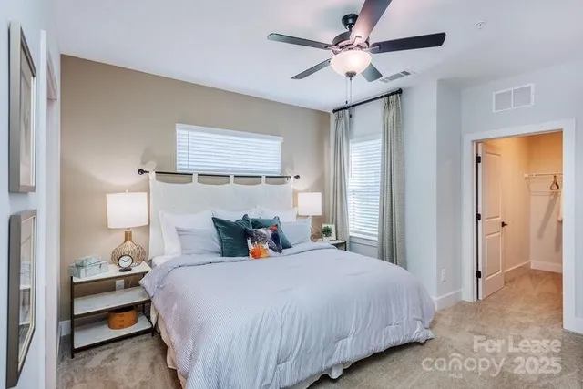 a bedroom with a bed and a ceiling fan