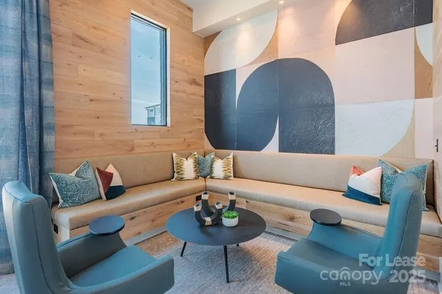 a living room with furniture and a mirror