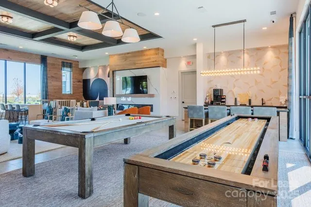 a room with furniture and view of kitchen