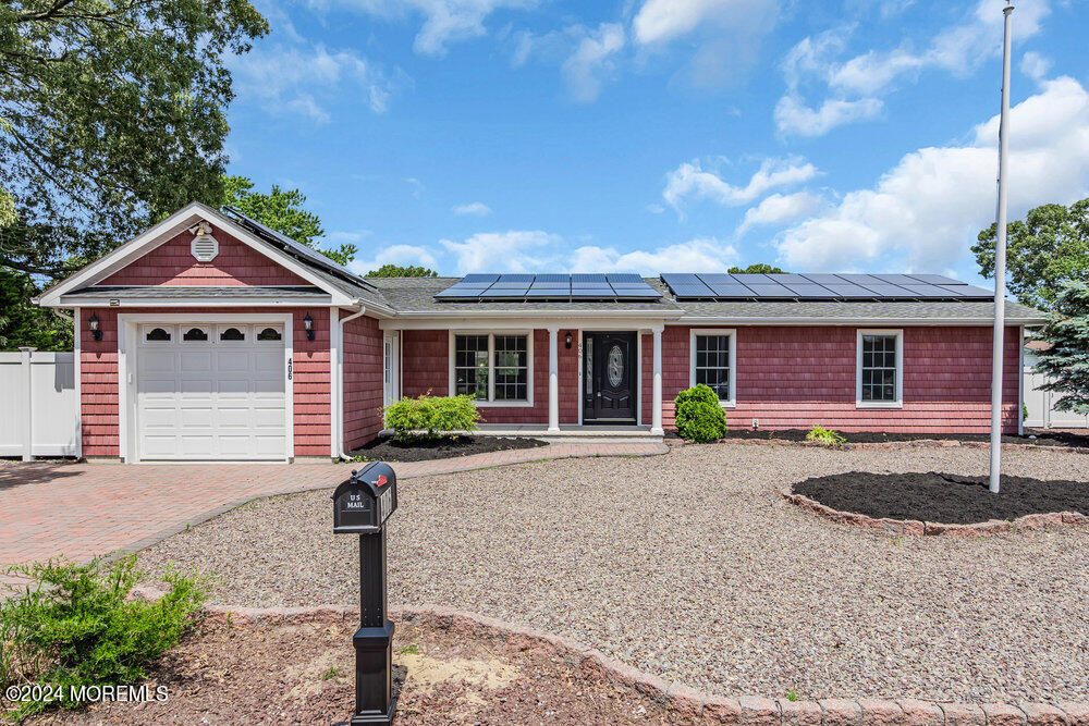 406 Laurel Boulevard Lanoka Harbor, NJ 08734 - Photo 1 of 1 a front view of a house with a yard and garage