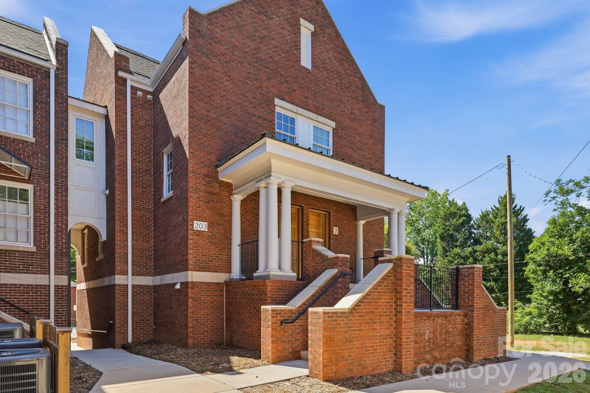 203 Grandin Road, Unit 1 Charlotte, NC 28208 - Photo 17 of 32 a view of a brick house with many windows
