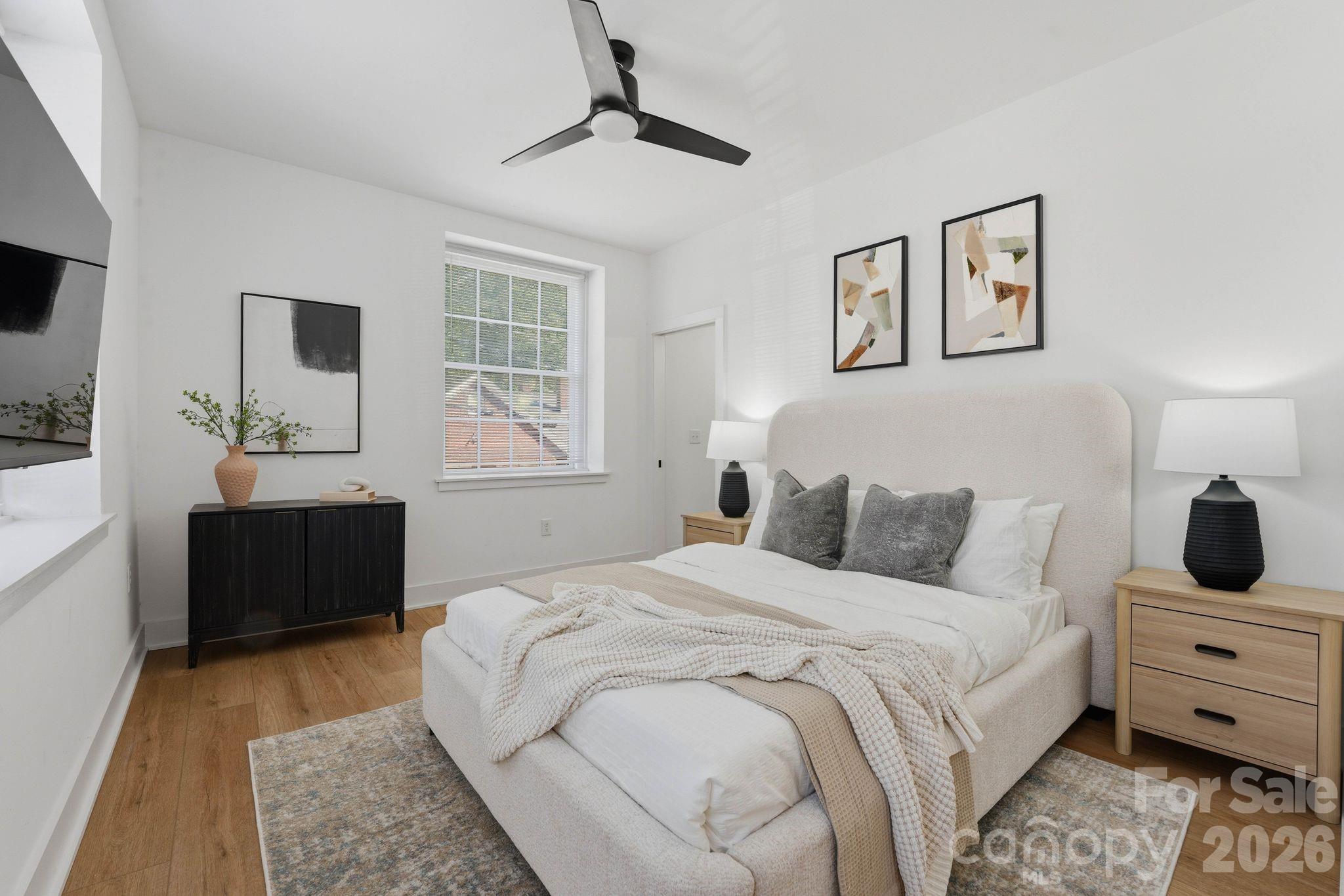 203 Grandin Road, Unit 1 Charlotte, NC 28208 - Photo 19 of 32 a bedroom with a large bed and a window
