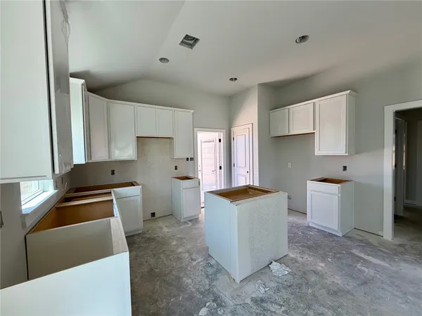 a kitchen with a stove a refrigerator and a sink