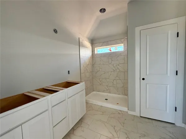 a bathroom with a bathtub and shower