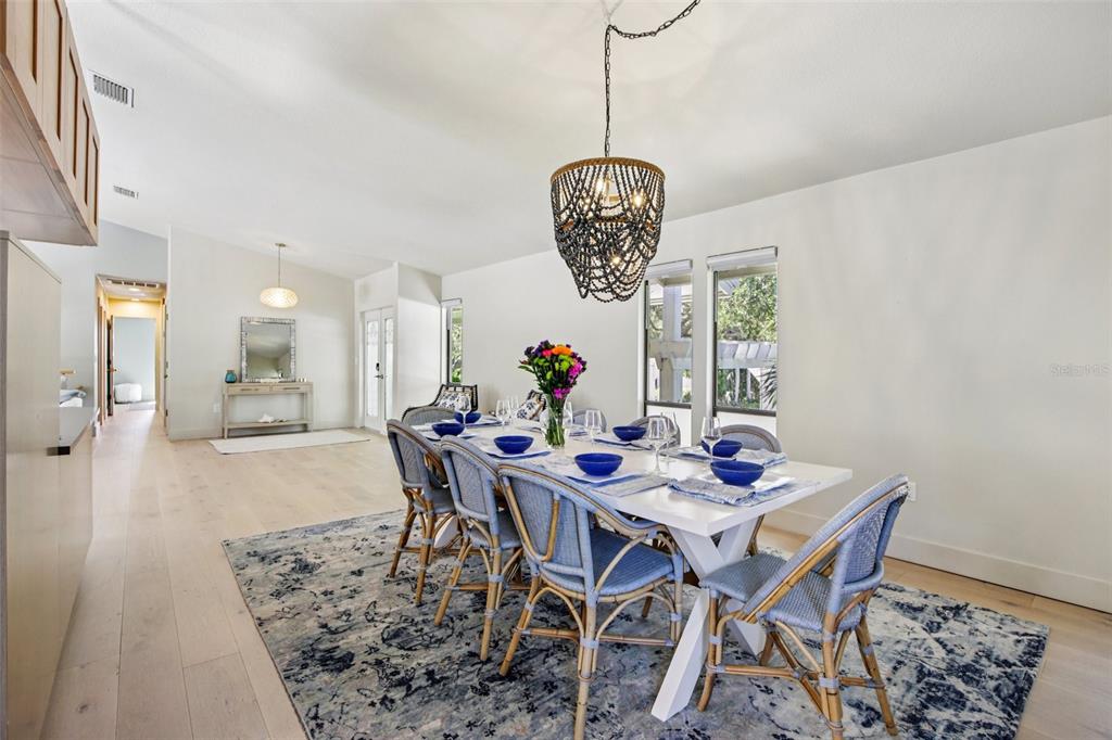 3390 Bayou Sound Longboat Key, FL 34228 - Photo 28 of 59 a view of a dining room and livingroom with furniture wooden floor a chandelier