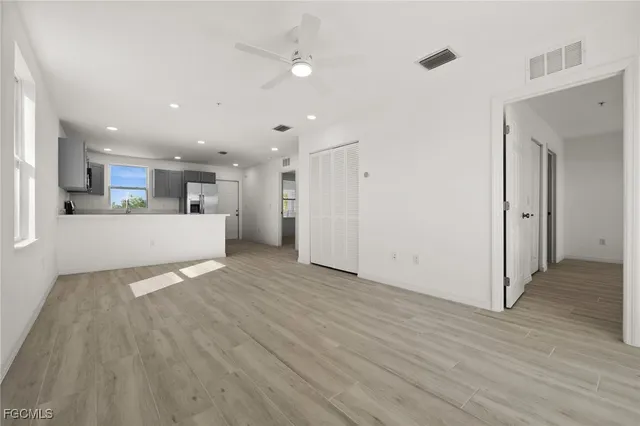 a view of a kitchen with a sink and a refrigerator