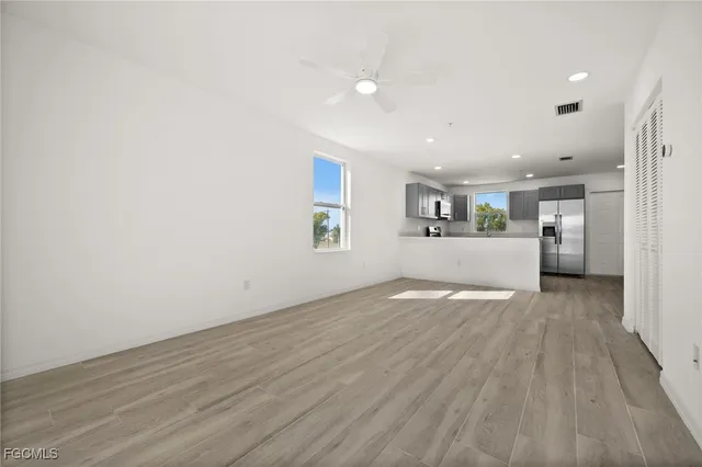 a view of a kitchen with a sink and a refrigerator