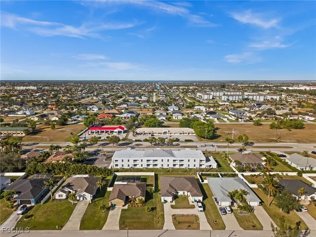 an aerial view of residential houses with city view