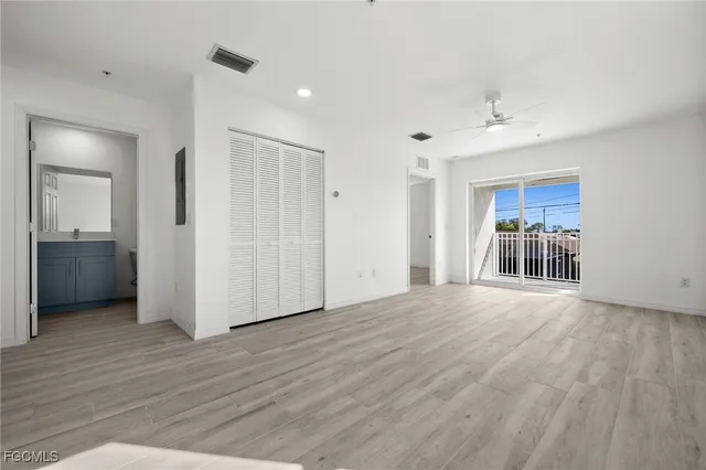a view of a livingroom with wooden floor and a ceiling fan