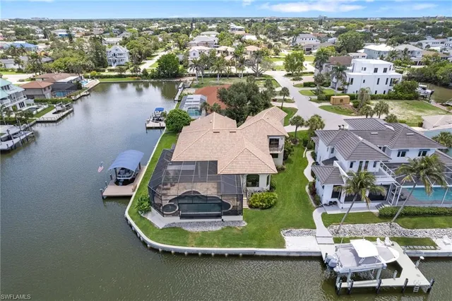 an aerial view of residential houses with outdoor space and lake view