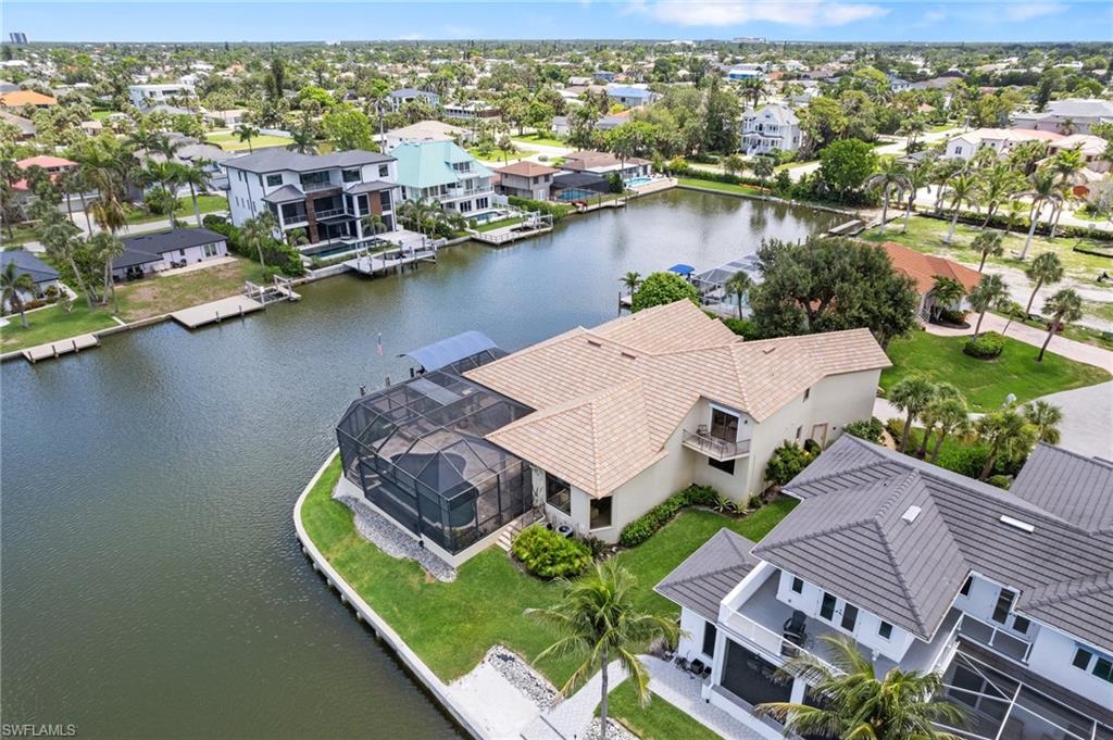 431 Palm Court Naples, FL 34108 - Photo 13 of 50 an aerial view of residential houses with outdoor space and lake view