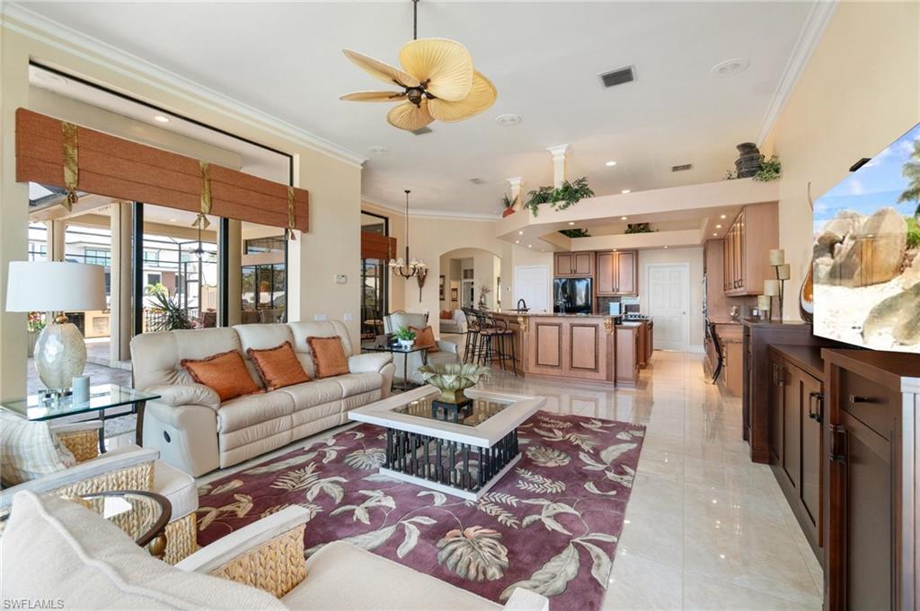 431 Palm Court Naples, FL 34108 - Photo 15 of 50 a living room with lots of furniture and a chandelier