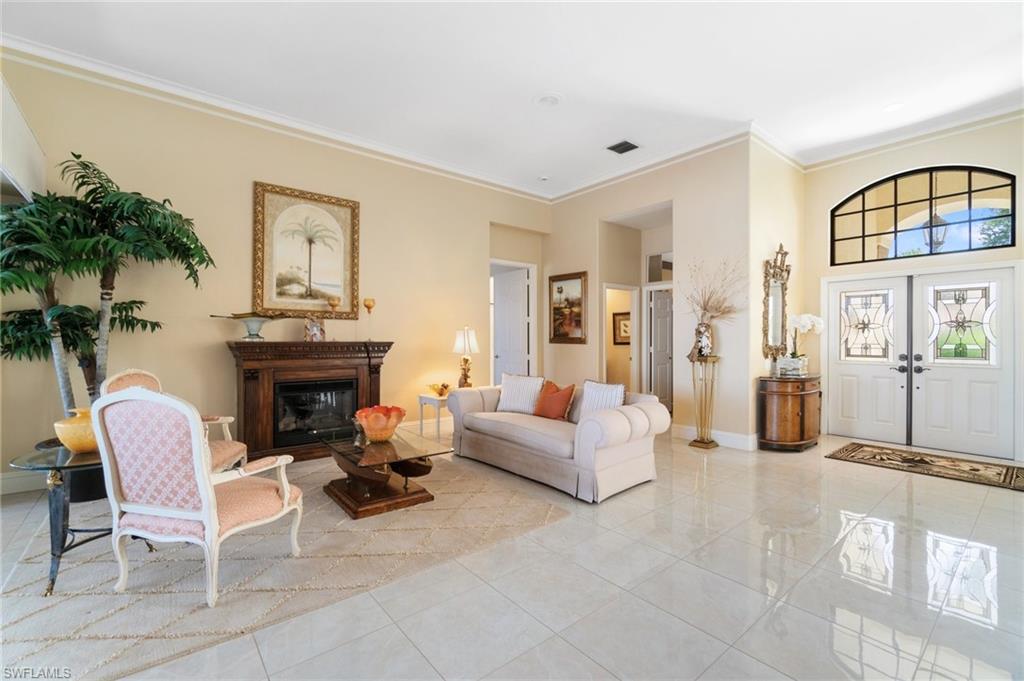 431 Palm Court Naples, FL 34108 - Photo 17 of 50 a living room with furniture and a fireplace