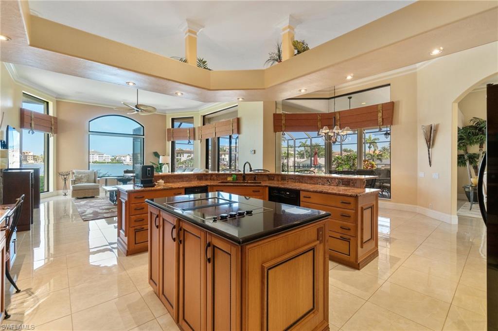 431 Palm Court Naples, FL 34108 - Photo 23 of 50 a kitchen with stainless steel appliances granite countertop a stove a refrigerator a oven and white cabinets
