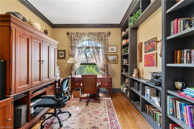 a spacious bedroom with a bed a couch and large windows