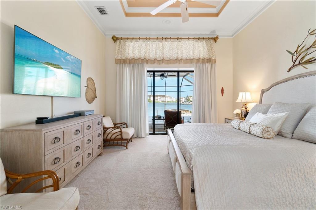 431 Palm Court Naples, FL 34108 - Photo 26 of 50 a spacious bedroom with a bed and a flat screen television