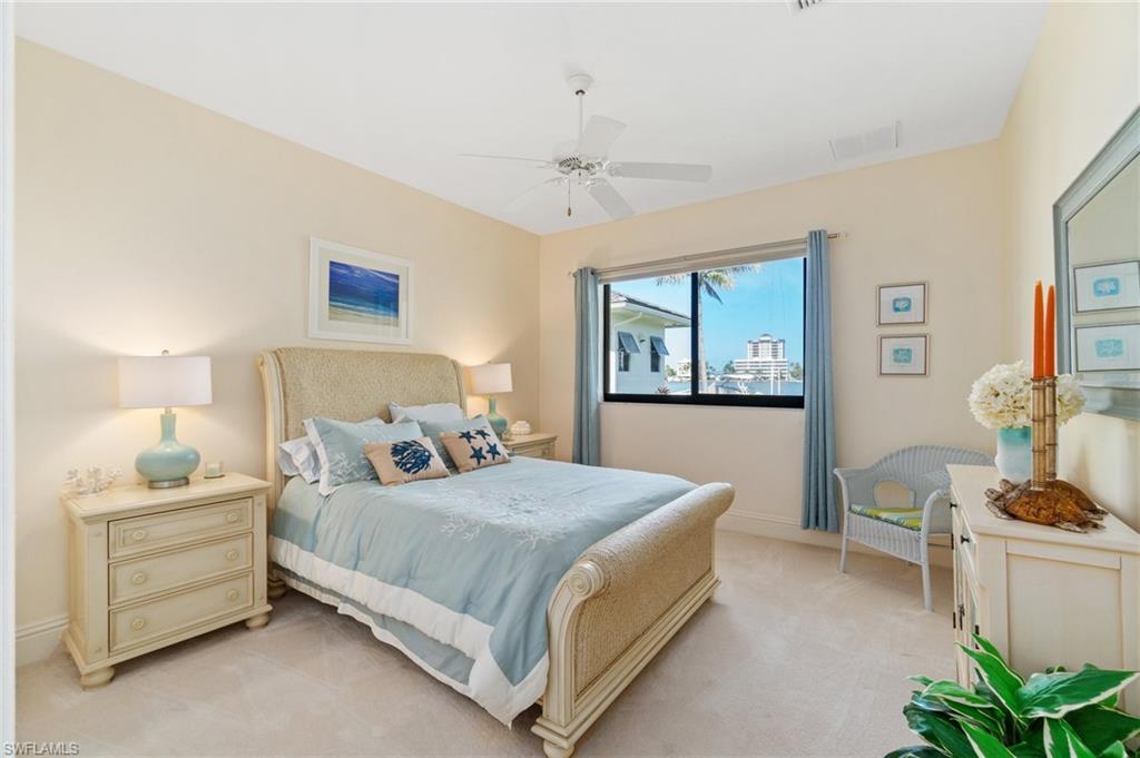 431 Palm Court Naples, FL 34108 - Photo 30 of 50 a bedroom with a bed and a window