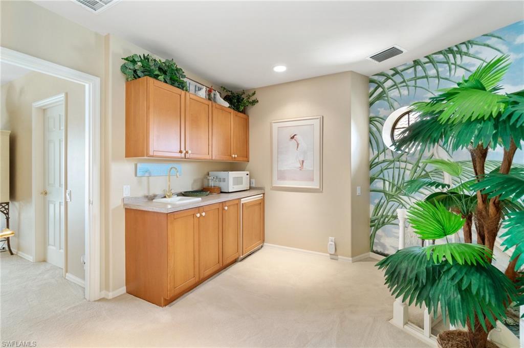 431 Palm Court Naples, FL 34108 - Photo 33 of 50 a kitchen with a white refrigerator a oven a sink and a potted plant