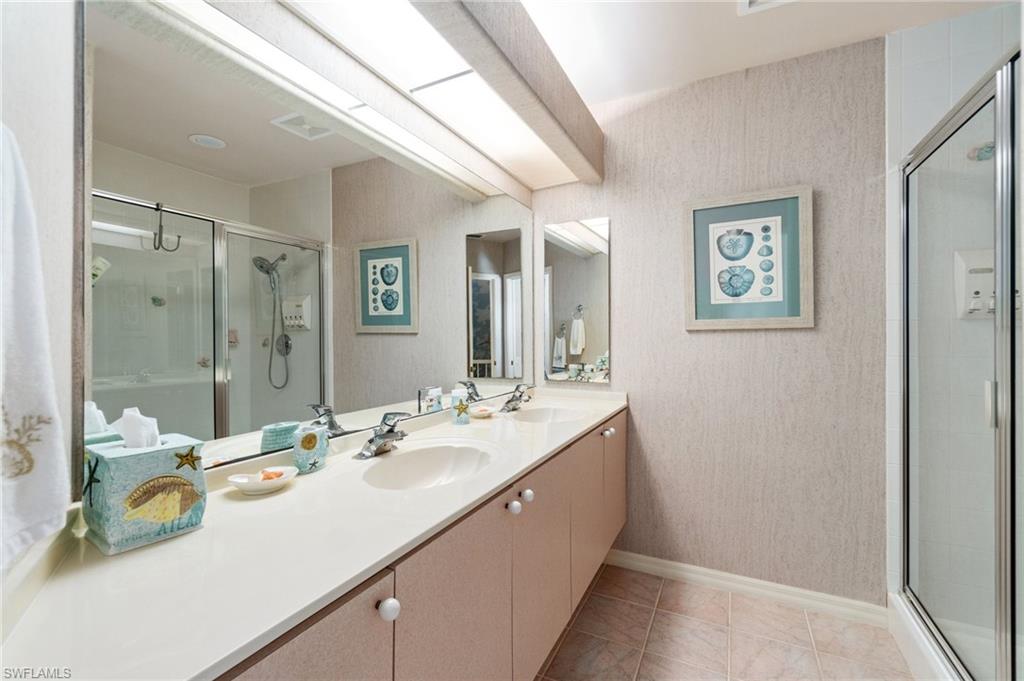 431 Palm Court Naples, FL 34108 - Photo 34 of 50 a bathroom with a sink double vanity and a mirror